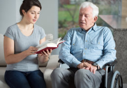caretaker reading story to her patient